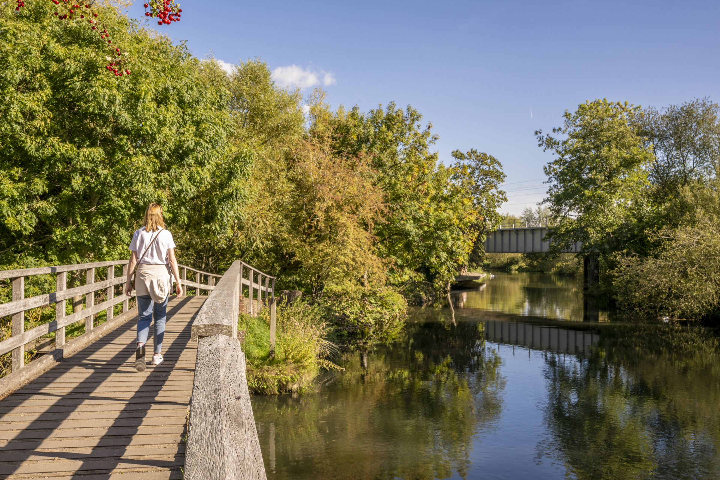 Woman walking along the canal path at Cherry Bird Lodge Escape in Newbury